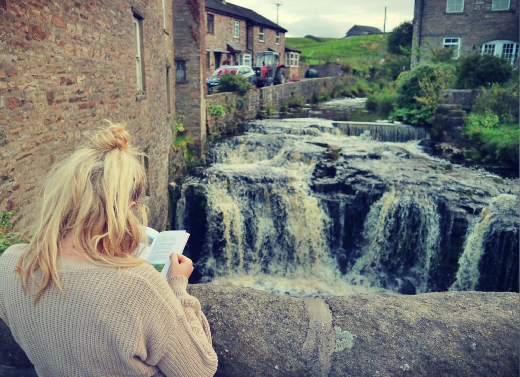 Woman in front of Hawes Waterfall