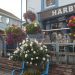 Colourful flower boxes on railings by outside seating area of HARBWR restaurant